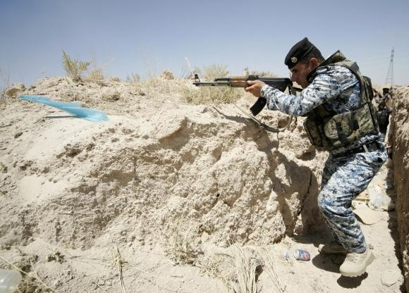 A member of the Iraqi security forces takes position during a patrol looking for militants of the ISIS at the border between Iraq and Saudi Arabia in June.