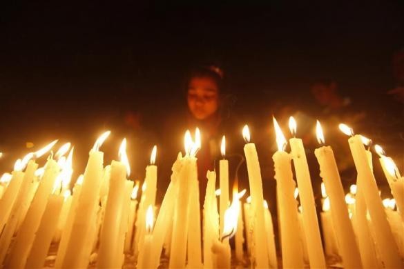 A girl lights candles during a candlelight vigil for a gang rape victim who was assaulted in New Delhi, in Kolkata