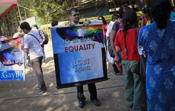 A gay rights activist holds a banner in protest of the Supreme Court ruling in Mumbai