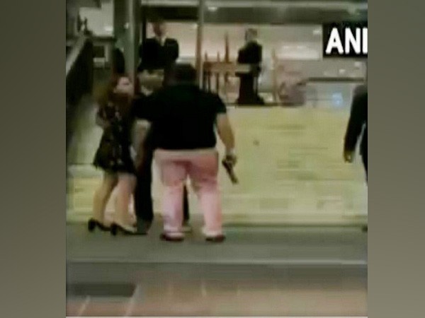 Pandey brandishing a gun outside Hyatt Regency Ashish Pandey
