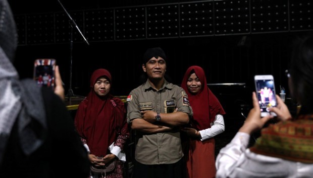 Staff at Boshe VVIP Club pose for pictures with Mifta'im An'am Maulana Habiburrohman, or Gus Miftah, a 37-year-old Muslim preacher who aims to create a safe space to worship for those who work in the entertainment industry, at one of his sermons in Kuta, Bali, Indonesia November 27, 2018. Mifta'im An'am Maulana Habiburrohman is not your typical Muslim preacher. Hardline Islamic groups have stepped up raids on bars and clubs in recent years, and have targeted sex workers and members of the LGBT community who work in entertainment zones. Mifta'im An'am Maulana Habiburrohman