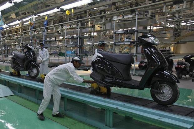 Employees work at an assembly line of Activa scooter at Honda Motorcycle and Scooter India Pvt. Ltd. plant in Tapukara, Rajasthan. Employees work at an assembly line of Activa scooter at Honda Motorcycle and Scooter India Pvt. Ltd. plant in Tapukara, Rajasthan.