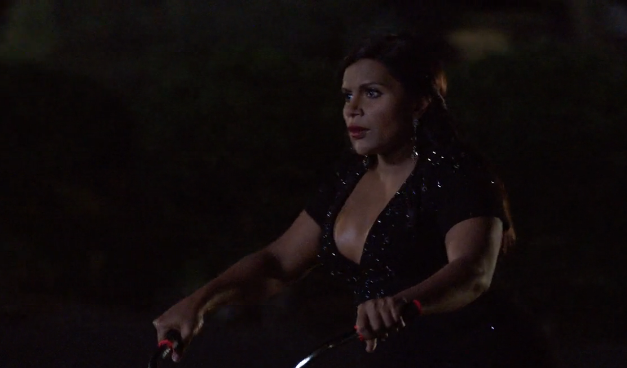 Mindy rides a bike to go see Danny. mindy 4