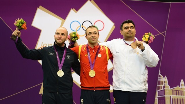 Gold medallist Alin George Moldoveanu (C) of Romania, silver medallist Niccolo Campriani of Italy (L) and bronze medallist Gagan Narang of India pose on the podium during the Victory Ceremony following the men's 10m Air Rifle Shooting final on Day 3. 10m Air Rifle medallists pose during Victory Ceremony