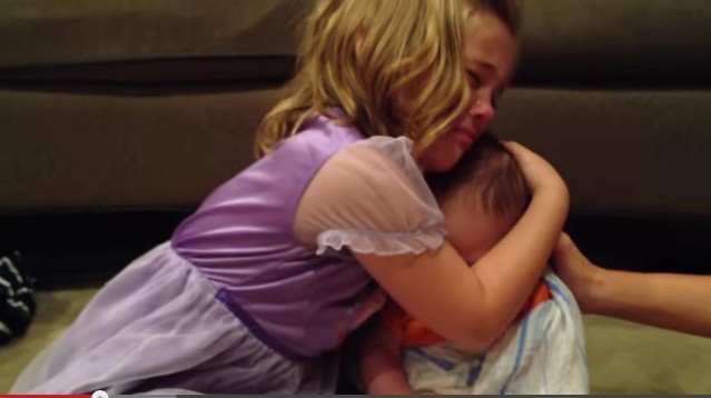 Sadie hugs her little brother while crying Sadie