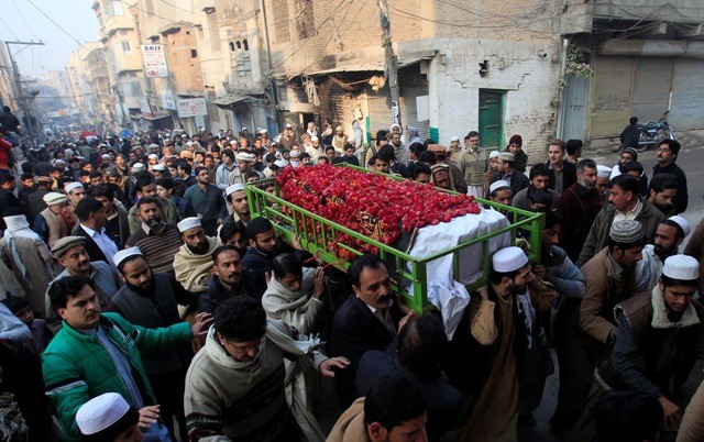People carry the coffin of a male student who was killed in Tuesday's attack on the Army Public School, which was attacked by Taliban gunmen, during his funeral in Peshawar, Peshawar attack