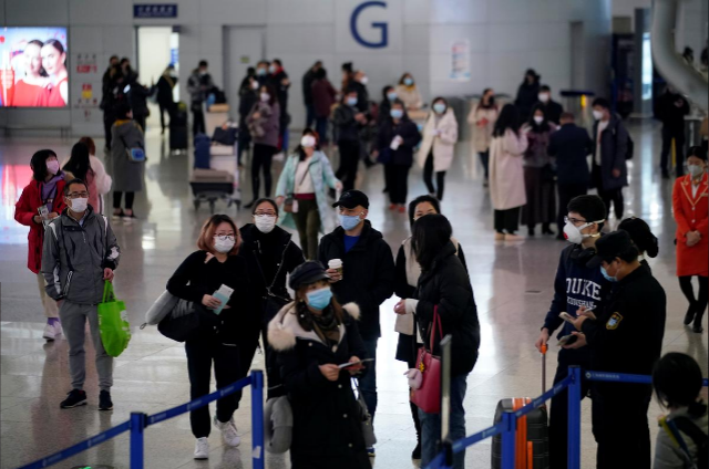 Passengers wearing mask at the airport. Reuters Coronavirus