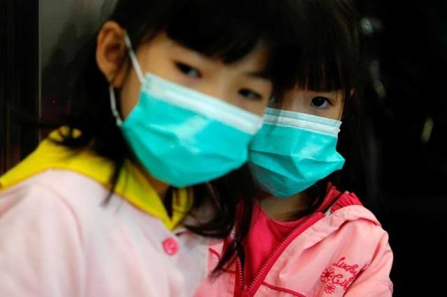 Children wear masks to prevent an outbreak of coronavirus. China virus outbreak