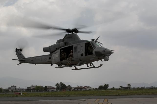 A UH-1Y Huey helicopter flies into the Tribhuvan International Airport after a search and rescue operation in Kathmandu, Nepal, May 13, 2015.