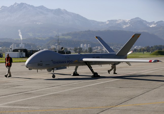Ground crew walks next to the Israeli Elbit Systems Ltd Hermes 900 unmanned aerial vehicle (UAV) during a presentation at the airbase in the central Swiss town of Emmen on October 16, 2012. The Adani group has tied up with Elbit for developing UAVs in India. Adani group ties up with Elbit Systems
