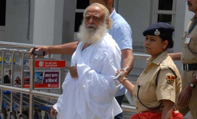 Asaram Bapu being escorted by police after his conviction. Asaram Bapu