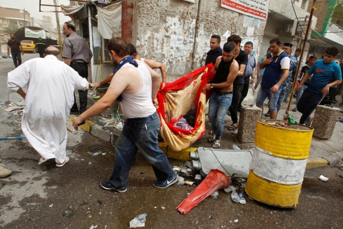Civilians carry the body of a victim killed in a suicide car bomb in the Karrada shopping area, in Baghdad, Iraq July 3, 2016. baghdad bombing