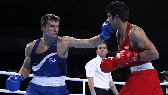 Antony Fowler lands a punch on Vijender Singh in middle-weight boxing final at the Commonwealth Games. Vijender Singh