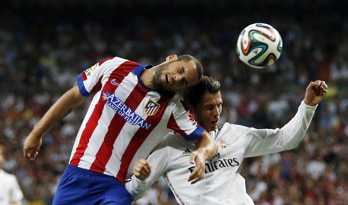 Atletico Madrid midfielder Mario Suarez and Real Madrid forward Cristiano Ronaldo fight for the ball during the first leg of their Spanish Super Cup clash Mario Suarez Atletico Madrid Cristiano Ronaldo Real Madrid