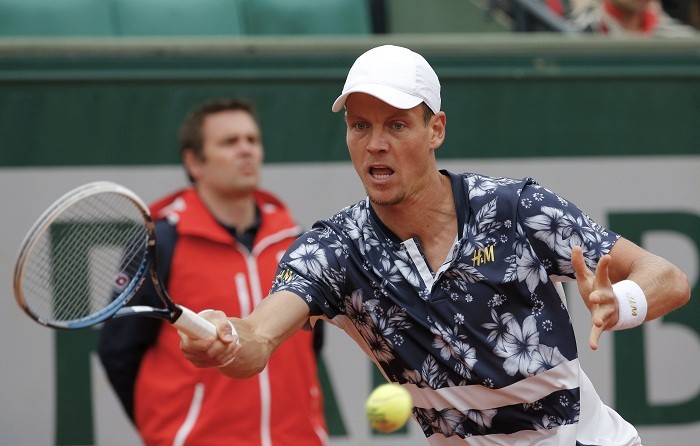 Tomas Berdych eturns a forehand to John Isner during their match at the French Open. Tomas Berdych