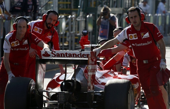 Mechanics push Kimi Raikkonen's Ferrari into the pits during a practice session at the Australian GP, 14 March. Reuters Ferrari Raikkonen F1