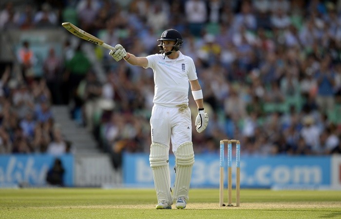 Joe Root raises his bat after completing his half-century Joe Root England