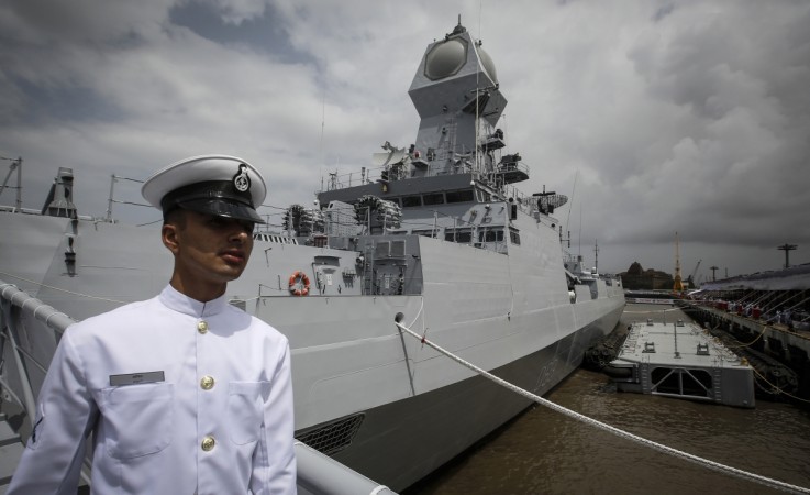 An Indian navy serviceman walks down the gangplank of the newly commissioned warship, INS Kolkata, during its commissioning ceremony at a naval base in Mumbai 16 August 2014. Indian Navy