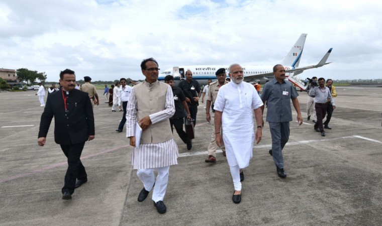Prime Minister Narendra Modi and Madhya Pradesh Chief Minister Shivraj Singh Chouhan photos to featured in house built under PMAY. Prime Minister Narendra Modi is welcomed by Madhya Pradesh Chief Minister Shivraj Singh Chouhan in Indore, Madhya Pradesh, on Aug. 9, 2016.