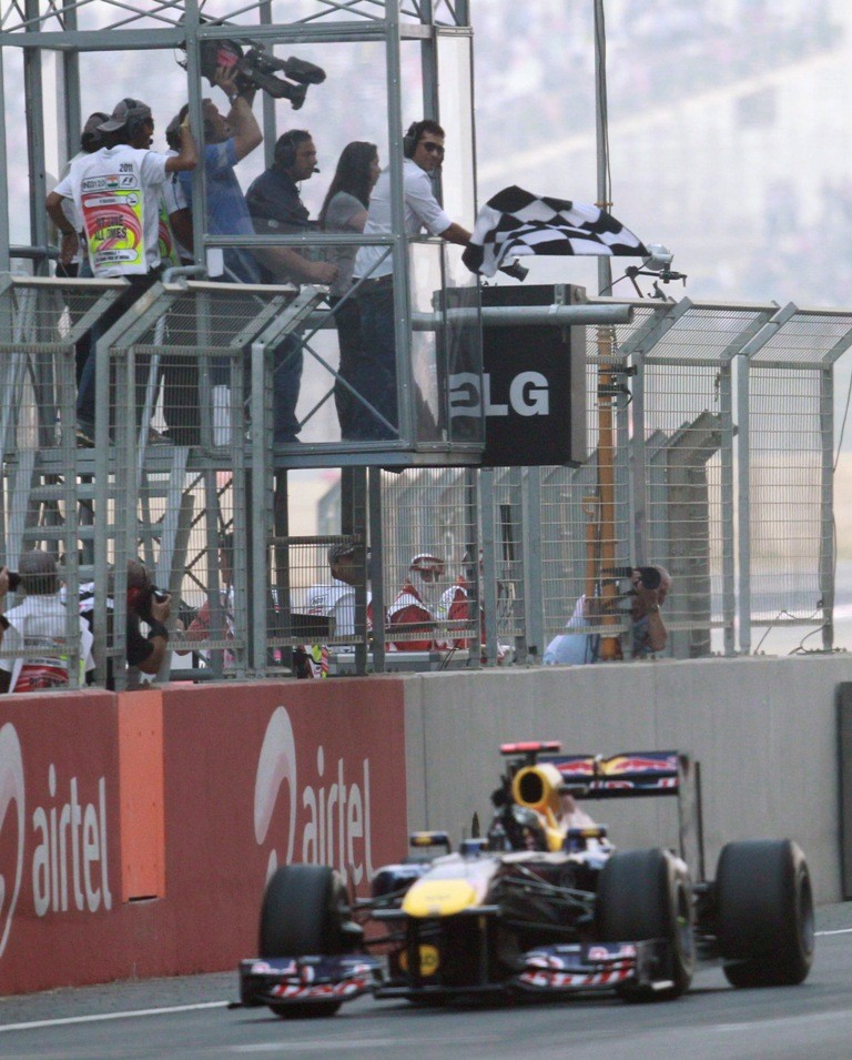 Sachin Tendulkar waves the chequered flag of first Indian Grand Prix of Formula 1 Sachin Tendulkar and Formula 1 Indian Grand Prix