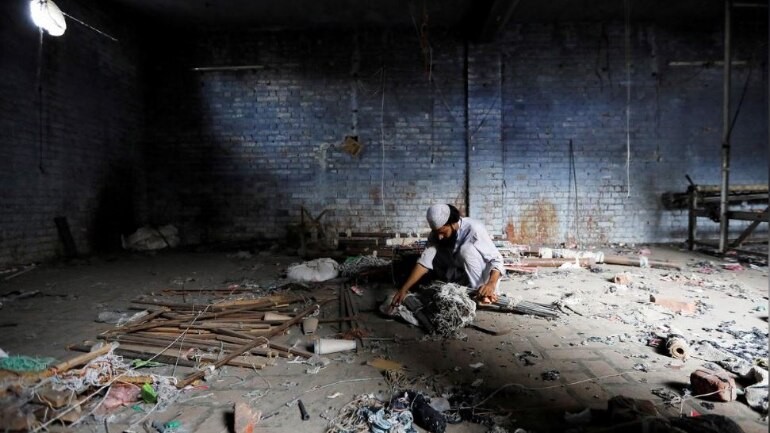 A scrap dealer searches for useful material at a weaving factory, that was shut a year ago, in Panipat in the northern state of Haryana, August 29, 2018. Indian economy