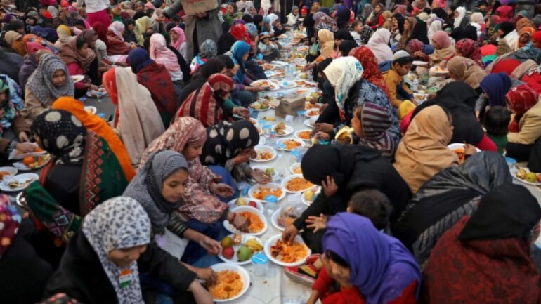 Local residents break their day-long fast as they attend a protest against a new citizenship law, New Delhi. CAA protests