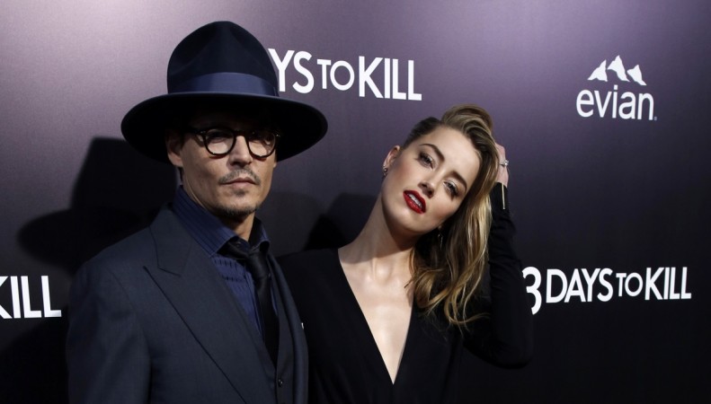 Cast member Amber Heard and her fiance, actor Johnny Depp, pose at the premiere of Amber Heard and Johnny Depp