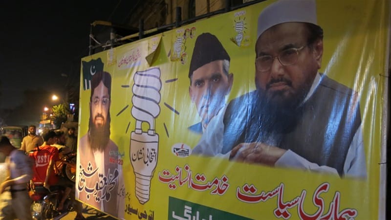 Saeed's photo on banners in Pakistan. saeed pak elections