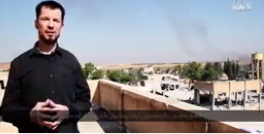 In its latest video, British journalist and ISIS prisoner reports from Kobani. The video claims that ISIS has taken over the town. Here Cantlie claims that from where he is standing he can see the Kurdish refugee camps. In its latest video, British journalist and ISIS prisoner reports from Kobani. The video claims that ISIS has taken over the town. Here Cantlie claims that from where he is standing he can see the Kurdish refugee camps.