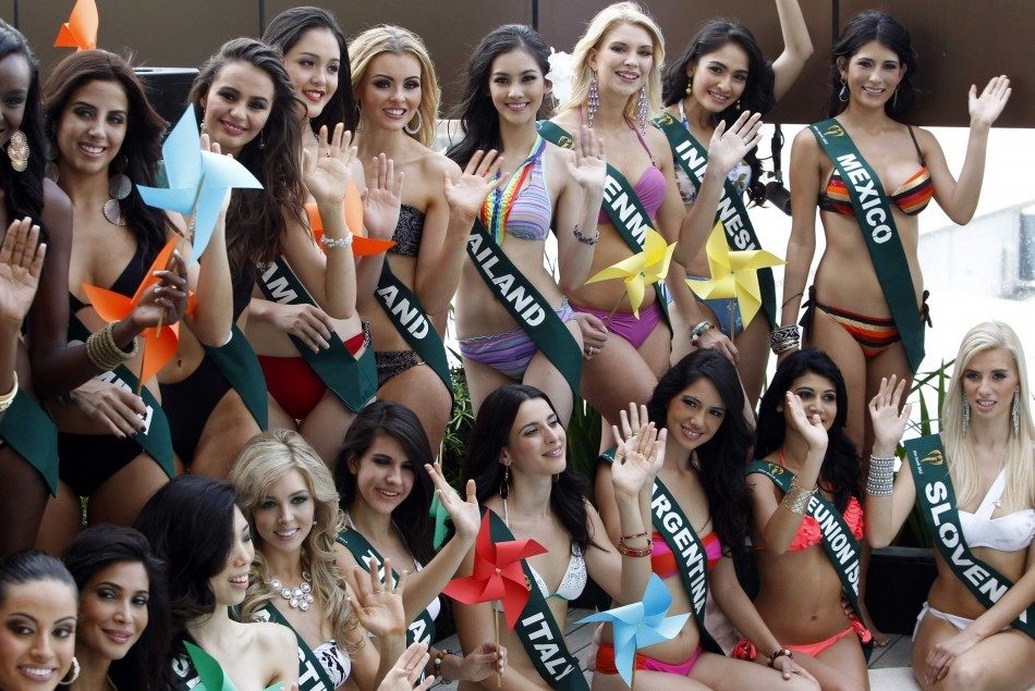 Candidates of the Miss Earth beauty contest, holding pinwheels to promote sustainable energy, wave to photographers during a media presentation at a hotel in Taguig City Miss Earth 2012