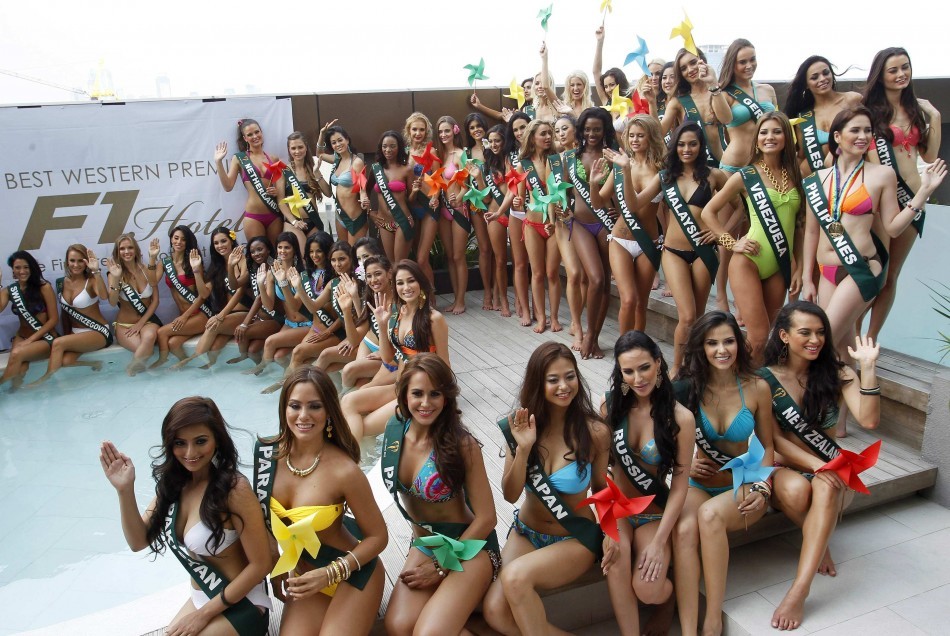 Candidates of the Miss Earth beauty contest, holding pinwheels to promote sustainable energy, wave to photographers during a media presentation at a hotel in Taguig City Miss Earth 2012