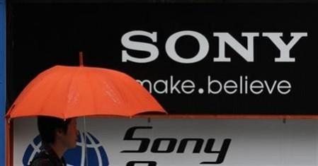 A man walks past a Sony logo in front of an electronic shop in Tokyo. New Android v4.4.2 KitKat Firmware gets Certified for Sony Xperia Z, ZL, Tablet Z: Report