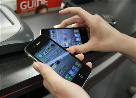 A customer holds iPhones she purchased shortly after the phone went on sale with the Verizon Wireless network in Boca Raton, Florida February 10, 2011.