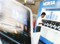 a-customer-looks-at-nokia-phones-at-a-showroom-run-by-softlogic-in-colombo