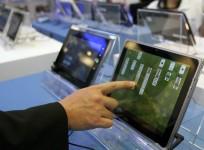 a-visitor-plays-with-a-tablet-pc-at-the-intel-booth-during-the-computex-2011-computer-fair-at-the-twtc-nangang-exhibition-hall-in-taipei