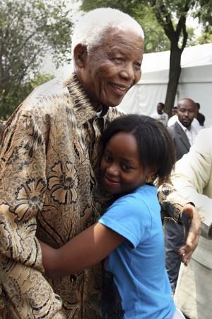 Handout picture of former South African President Nelson Mandela hugging his great granddaughter Zenani Mandela in Diepkloof, Soweto