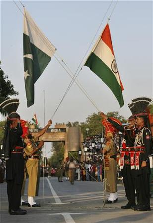 Pakistani Rangers and BSF lower their respective country flags during daily parade in Pakistan India joint check post in Wagah border