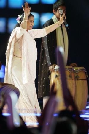 Asha Bhosle reacts to fans cheering while performing among Asian and Western pop stars in the MTV Asia Aid benefit concert in Bangkok. Indian musical artist Asha Bhosle reacts to fans cheering while performing among Asian and Western pop stars in the MTV Asia Aid benefit concert in Bangkok, February 3, 2005. The concert was being held to benefit tsunami victims. Asha Bhosle