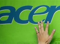 a-man039s-hand-is-seen-on-an-acer-logo-as-he-pastes-a-poster-below-at-a-computer-mart-in-taipei