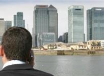 man-speaks-on-his-mobile-phone-on-a-boat-on-the-river-thames