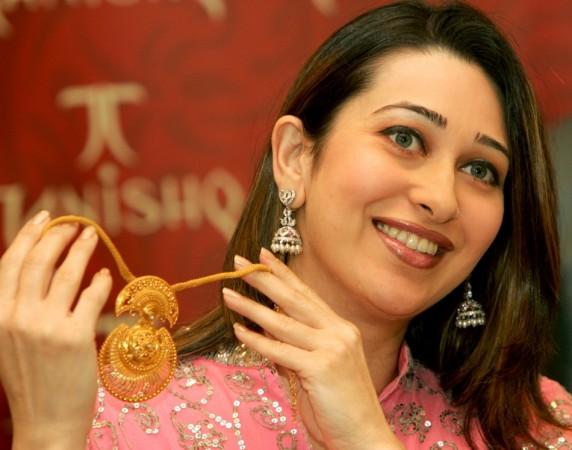 Bollywood actress Karisma Kapoor displays a necklace during the launch of a new range of jewelery in New Delhi, on October 14, 2004. Karisma Kapoor