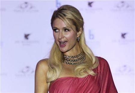 Paris Hilton poses for photographers while wearing an Indian-inspired dress during a news conference in Mumbai