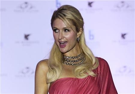 Paris Hilton poses for photographers while wearing an Indian-inspired dress during a news conference in Mumbai September 24, 2011. Paris Hilton poses for photographers while wearing an Indian-inspired dress during a news conference in Mumbai