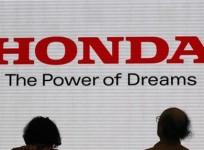 visitors-are-silhouetted-against-a-logo-of-the-honda-motor-at-the-company-showroom-in-tokyo