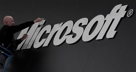 A worker prepares the logo on the Microsoft stand on the CeBIT computer fair in Hanover.