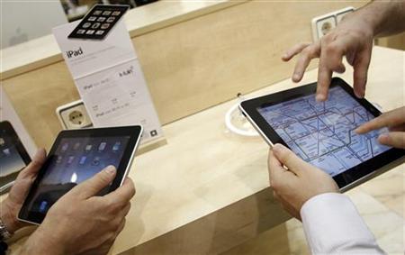Visitors check out the new Apple iPads at an Apple retail store in Madrid