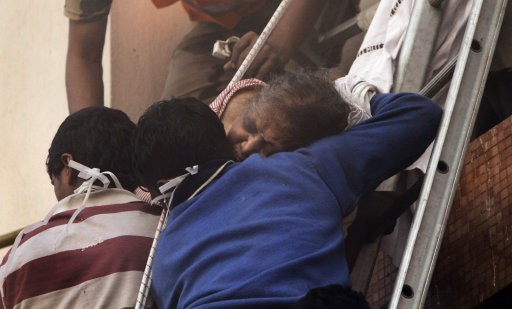 Fire officials and hospital staff rescue a patient from the window of a nursing home after it caught fire in AMRI Hospital, Kolkata. AMRI/Kolkata Fire