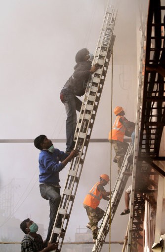 Fire officials rescue a patient from the window. AMRI/Kolkata Fire