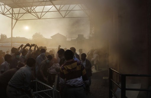 People rescue patients after a fire broke out. AMRI/Kolkata Fire