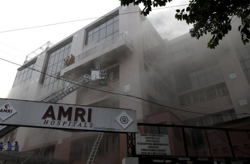 Fire officials try to rescue patients trapped inside the hospital. AMRI/Kolkata Fire